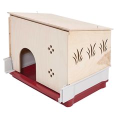 a wooden dog house with red carpet and white trim