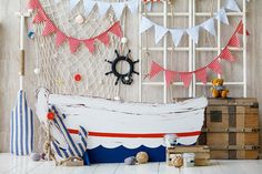 a white boat sitting on top of a floor next to a shelf filled with boxes