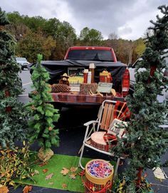 the back of a pick up truck with furniture in it's bed and two chairs