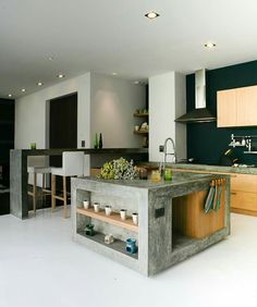 a kitchen with an island made out of concrete