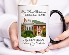 a woman holding a coffee mug in her hands with the words our first christmas in our new home