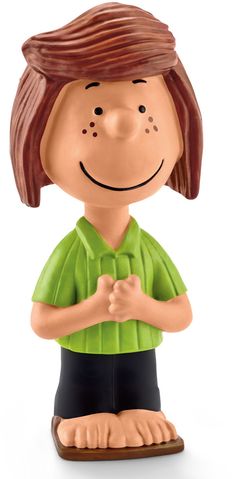 a figurine of a boy with brown hair and green shirt is standing in front of a white background