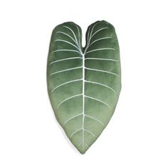 a large green leaf shaped pillow on a white background with the shape of a heart