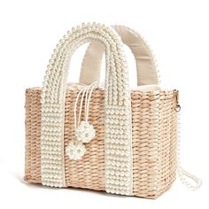 Our pearl basket tote bag is handmade and embellished with faux pearls. It is fully lined and closed with a drawstring tie finished off with pearl spheres. The long pearl strap is perfect for those moments when you want to switch it up to a shoulder bag. The shoulder strap is delicate and therefore you should take care not to overload the bag with heavy items. Measurements Height 17cm Width 12cm Length 25cm Luxe Handbags, Grandmillennial Style, Handbags Handmade, Woven Bags, Basket Tote, Basket Woven, Straw Basket, Woven Handbags, Straw Handbags