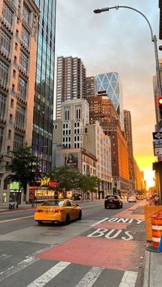 a city street filled with lots of tall buildings and traffic lights next to each other