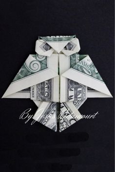 an origami bird made out of dollar bills