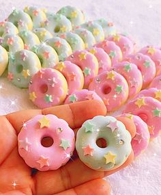 there are many doughnuts in the palm of someone's hand with stars on them