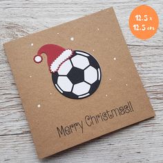 a christmas card with a soccer ball and santa hat