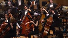 a group of people in tuxedos playing musical instruments