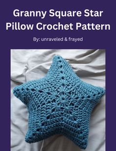 a blue crocheted star pillow sitting on top of a white bed with the words granny