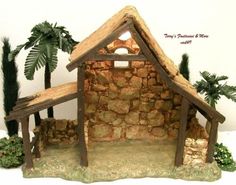 a nativity scene with a stone building and palm trees