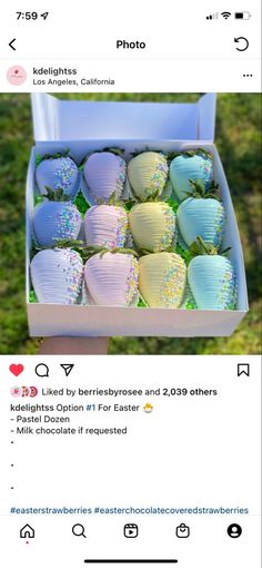 an open box filled with lots of different colored paper lanterns on top of green grass