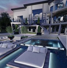 a large house with a swimming pool and lounge chairs in front of it at night