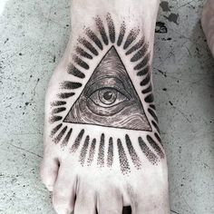 a person's foot with an all seeing eye tattoo on it