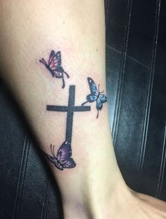 a cross with three butterflies on it