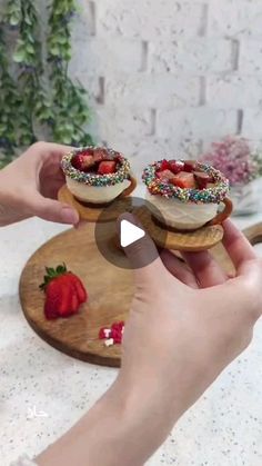 two small cakes with sprinkles and strawberries on them