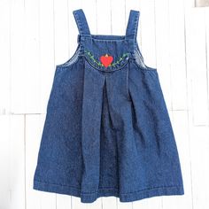 This Vintage Blue Jean Denim Overall Girl's Dress, is adorned with an endearing Heart Embroidery on the bib - a delightful piece from the Vintage Winnie the Pooh Brand that encapsulates the essence of nostalgia. This vintage girl's dress, tailored in size 6X, is a blend of retro charm and everyday practicality. Its blue jean denim composition brings a touch of timeless style, while the heart embroidery adds a whimsical touch.  Designed with attention to detail, this dress comes complete with the convenience of an overall-style design.  As with all our pieces, it's important to recognize that these items are pre-owned or vintage, carrying the stories of the past. This dress may bear signs of wear and tear, enhancing its vintage character. I encourage you to check the images thoughtfully pre Cute Denim Dress For Playdate, Cute Cotton Denim Dress, Cute Cotton Denim Dress In Denim Blue, Cute Denim Blue Cotton Dress, Medium Wash Cotton Denim Dress With Floral Embroidery, Medium Wash Embroidered Cotton Dress, Medium Wash Denim Dress With Floral Embroidery, Cute Medium Wash Denim Dress, Embroidered Medium Wash Cotton Denim Dress