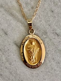 "*Listing is for 5/8th inch round 14K yellow gold St Jude pendant pictured in first picture with writing, plus a 16\" 14K yellow gold chain in the second photo, price includes both and free shipping* Saint Jude round medal / medallion / pendant / charm Saint of lost causes amongst other traits. A beautiful special gift for a loved one. -solid 14k yellow gold, not plated or gold filled. -approximately 5/8th inch in length and bit under 1/2 inch wide , smallest size compared to other options in ou Rope Wedding Band, Mens Wedding Bands Tungsten, St Jude, Oval Necklace, Round Necklace, Tungsten Wedding Bands, Yellow Gold Chain, Gold Charm, Christening