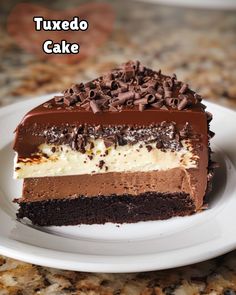 a piece of cake on a plate with chocolate and white frosting that says tuxedo cake