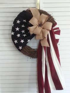 an american flag wreath hanging on the side of a door