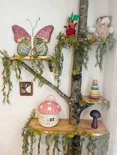 the shelves are decorated with fairy figurines and other items, including a mushroom - shaped basket