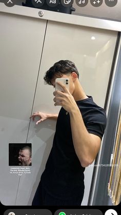 a man taking a selfie in front of a mirror with his cell phone up to his face