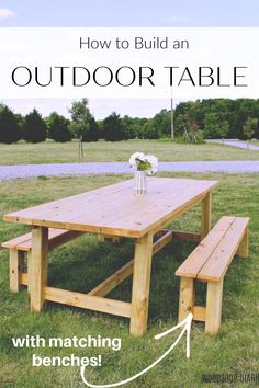 a wooden picnic table with benches in the grass