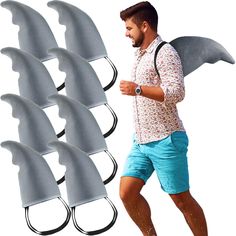 the man is running with six shark fin attachments on his back and in front of him