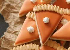 several pieces of food are arranged in the shape of pyramids with white icing on them