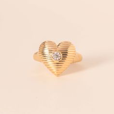 Carrying your heart on your fingers, literally. The solid gold textured heart ring is equally dreamy and bold. The diamond in the middle is the cherry on top of the piece, it adds that special glow. 14k solid gold Average diamond weight is 0.13cts Heart dimensions: 15 x 16mm Promise Heart Ring With Single Diamond, Heart-shaped Diamond Ring With Single Diamond, Valentine's Day Heart Ring With Single Diamond, Diamond Cut Heart Ring For Valentine's Day, Valentine's Day Heart Ring With Diamond Cut, Valentine's Day Diamond Cut Heart Ring, Valentine's Day Heart-shaped Diamond Cut Heart Ring, Heirloom Diamond Heart Ring, Sparkling Rings