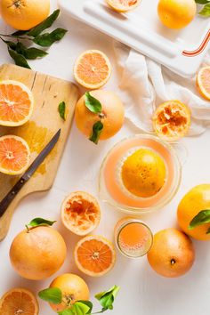 an assortment of oranges on a cutting board