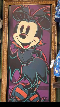 the mickey mouse painting is on display in front of other shoes and clothing hanging from shelves