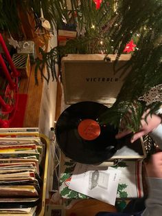 a record player picks up some records from a christmas tree