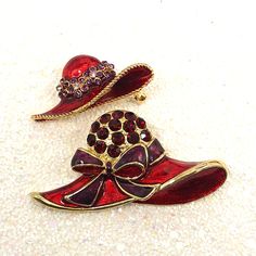 Two Vintage Red Hat Society Rhinestone And Enamel Brooches. The smaller red hat is decorated with purple and clear rhinestones and measures 1 3/4" x 7/8". The larger red hat brooch also has a beautiful shiny enamel and is adorned with large red rhinestones and a purple and red bow. It measures 2 3/8" x 1 1/4".All jewelry items are shipped in a small organza or velvet jewelry bag or jewelry box.Feel free to message me with any questions. Fast shipping and handling from Birmingham, Alabama.Looking Hat Brooch, Red Hat Society, Purple Decor, Velvet Jewelry, Birmingham Alabama, Murano Glass Beads, Enamel Brooch, Jewelry Bag, Red Hat