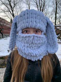 a woman wearing a knitted hat with a beard