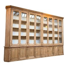 an old wooden bookcase with glass doors on the top and bottom shelves, isolated against a white background