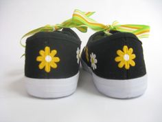 PLEASE SEE OUR SIZE CHART TO SELECT YOUR SIZE. SHOES TEND TO RUN SMALL. These cute daisy shoes have a striking design. We hand painted beautiful yellow and white flowers on our black canvas sneakers. We have added a bright yellow ribbon for the laces. Ribbons may vary according to availability. Perfect for summer time fun. PLEASE use our size chart below when selecting your size as some think they tend to run small. Some think the shoes are not sized like national brands. Measurements are taken Spring Yellow Canvas Shoes With Rubber Sole, Yellow Lace-up Canvas Shoes For Spring, Yellow Canvas Sneakers For Spring, Cute Yellow Sneakers For Spring, Flowers On Black Canvas, Daisy Shoes, Black Canvas Sneakers, Yellow And White Flowers, On Black Canvas