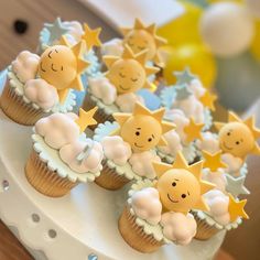 cupcakes decorated with stars and clouds on a cake stand