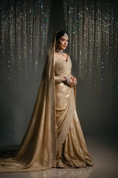 A stunning portrait of a Pakistani bride wearing a champagne gold saree that radiates understated luxury. The saree is crafted from a glittering fabric that catches the light, creating a mesmerizing shimmering effect. The subtle embellishments throughout the saree add to its elegance, while the long train adds a dramatic flair. Royal Bridal Saree, Bridal Saree For Reception, Fruits Photoshoot, Marriage Saree, Shloka Mehta, Bridal Things, Radhika Merchant, Gold Saree