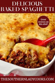 a casserole dish with meat and cheese in it on a red checkered table cloth