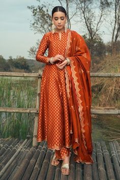 Burnt orange vegan silk anarkali with floral weaving pattern. Comes with pant and a dupatta. - Aza Fashions Anarkali Silk Dress, Anarkali Silk Suits, Party Anarkali Suits, A Line Salwar Suits, Red Duppata Contrast Suit, Anarkali Sets For Women, White Anarkali Dress With Red Dupatta, Burnt Orange Indian Outfit, Anarkali Suits Silk