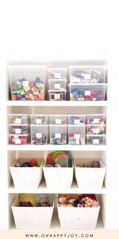 a white shelf filled with lots of plastic bins