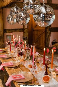 a long table with plates and candles on it