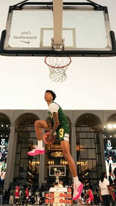 a basketball player jumping up into the air to dunk