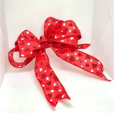 a red bow with hearts on it