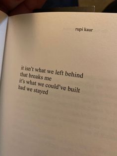 an open book with the words rupi kaur written in cursive writing