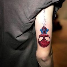 a spider man tattoo on the arm