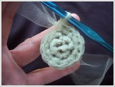 someone is crocheting an object in their hand