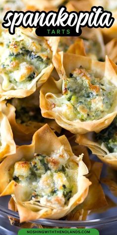 spinach and cheese tarts in small shells on a glass platter with text overlay