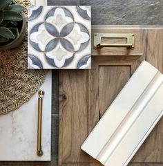 an assortment of decorative items on top of a wooden table next to a potted plant